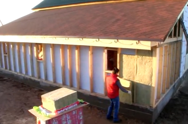 Nous construisons une maisonIsolation d'une maison en bois à l'extérieur avec du plastique mousse avec nos propres mains sous le revêtement